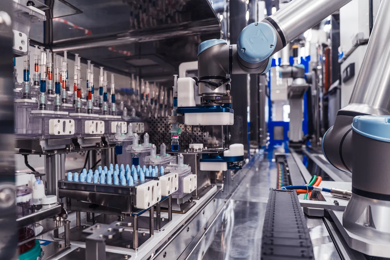 Robotic arm holding syringe inside cluster